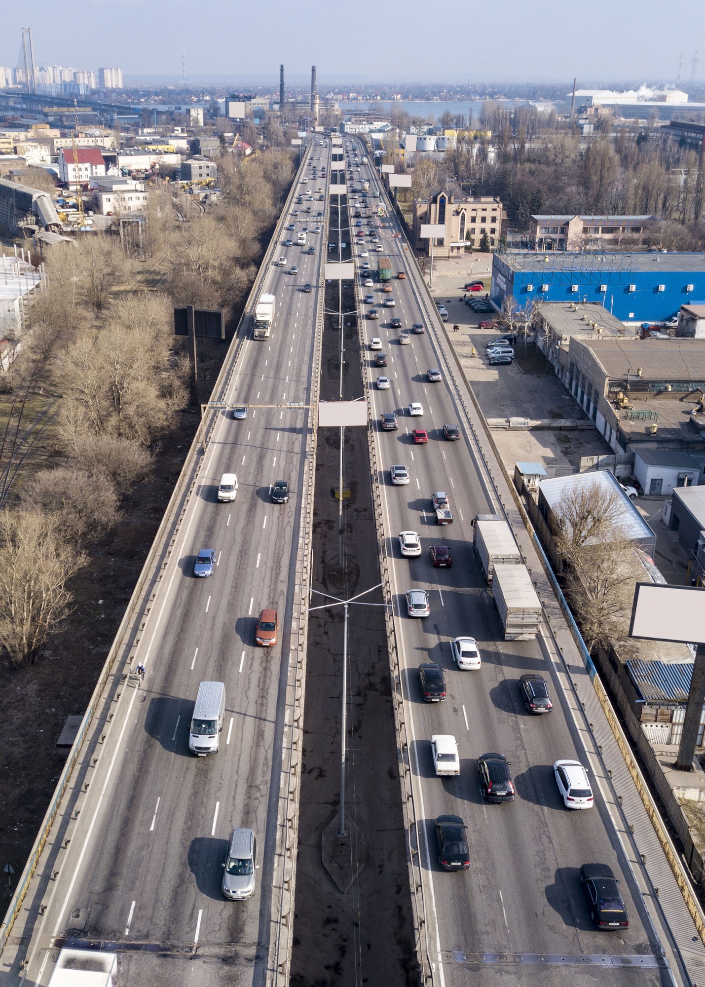 Highway with moving cars and trucks in the city Kiev, Ukraine. Aerial view from drone in a spring
